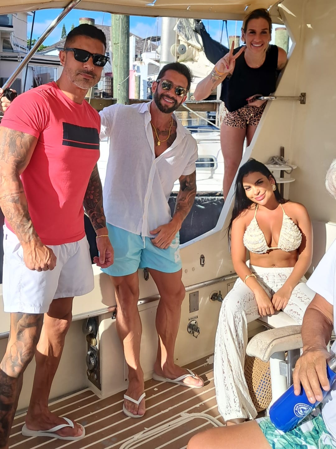 Family on the deck of a small fishing charter boat preparing rods